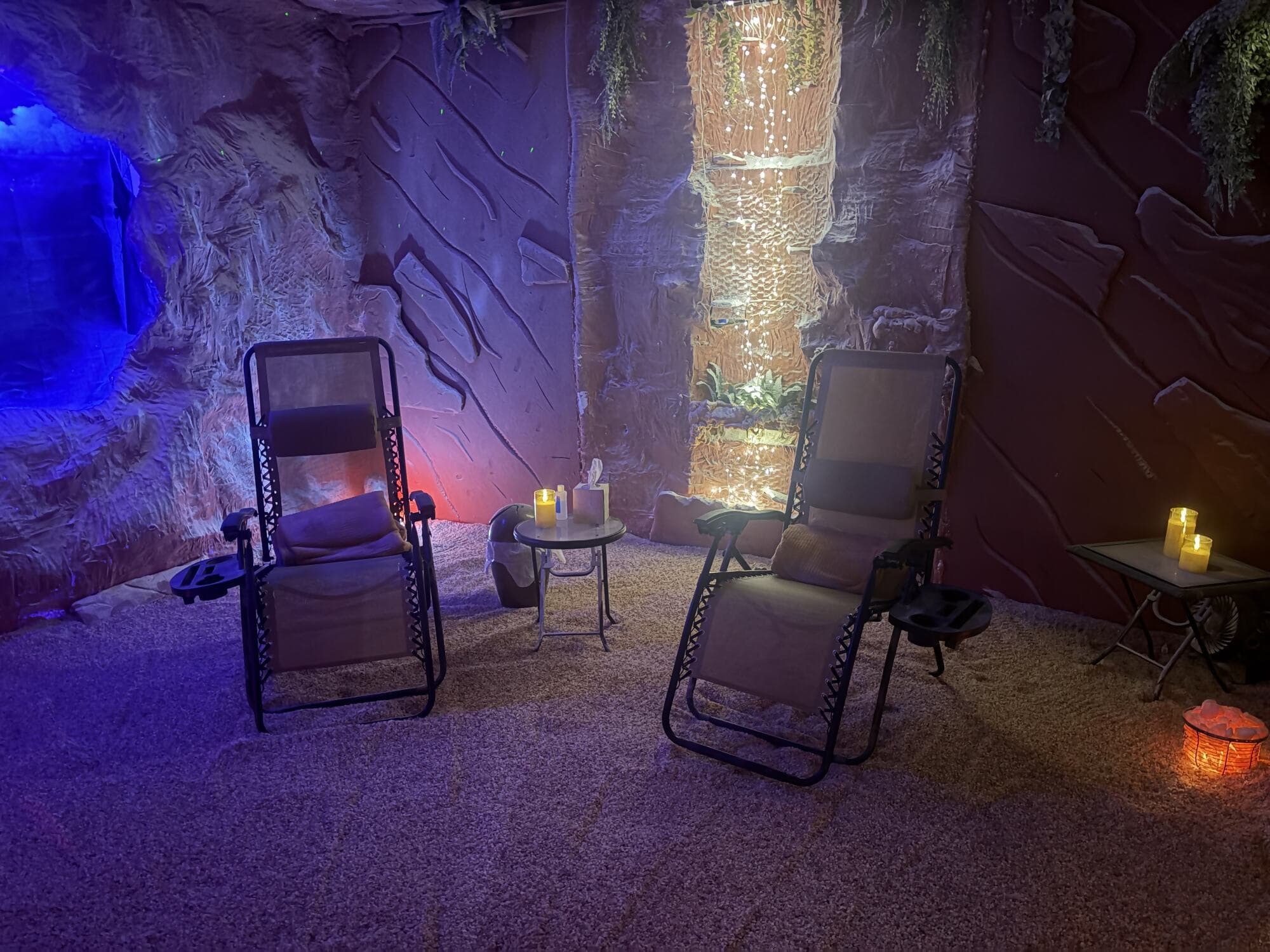 Two zero-gravity recliners facing the glowing waterfall wall