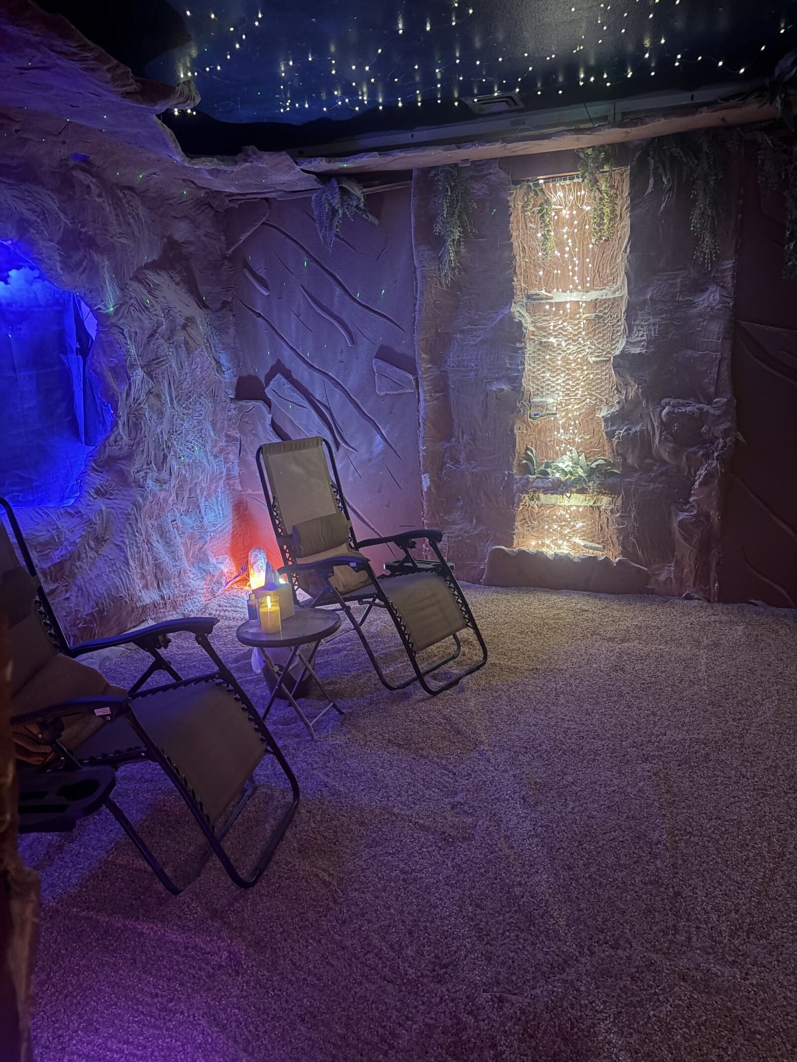 Inside the Serenity salt cave — recliners beneath a fiber-optic starlit ceiling